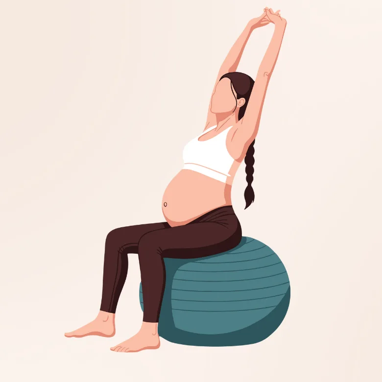Prenatal yoga: pregnant woman stretching her arms up while seated on a birthing ball